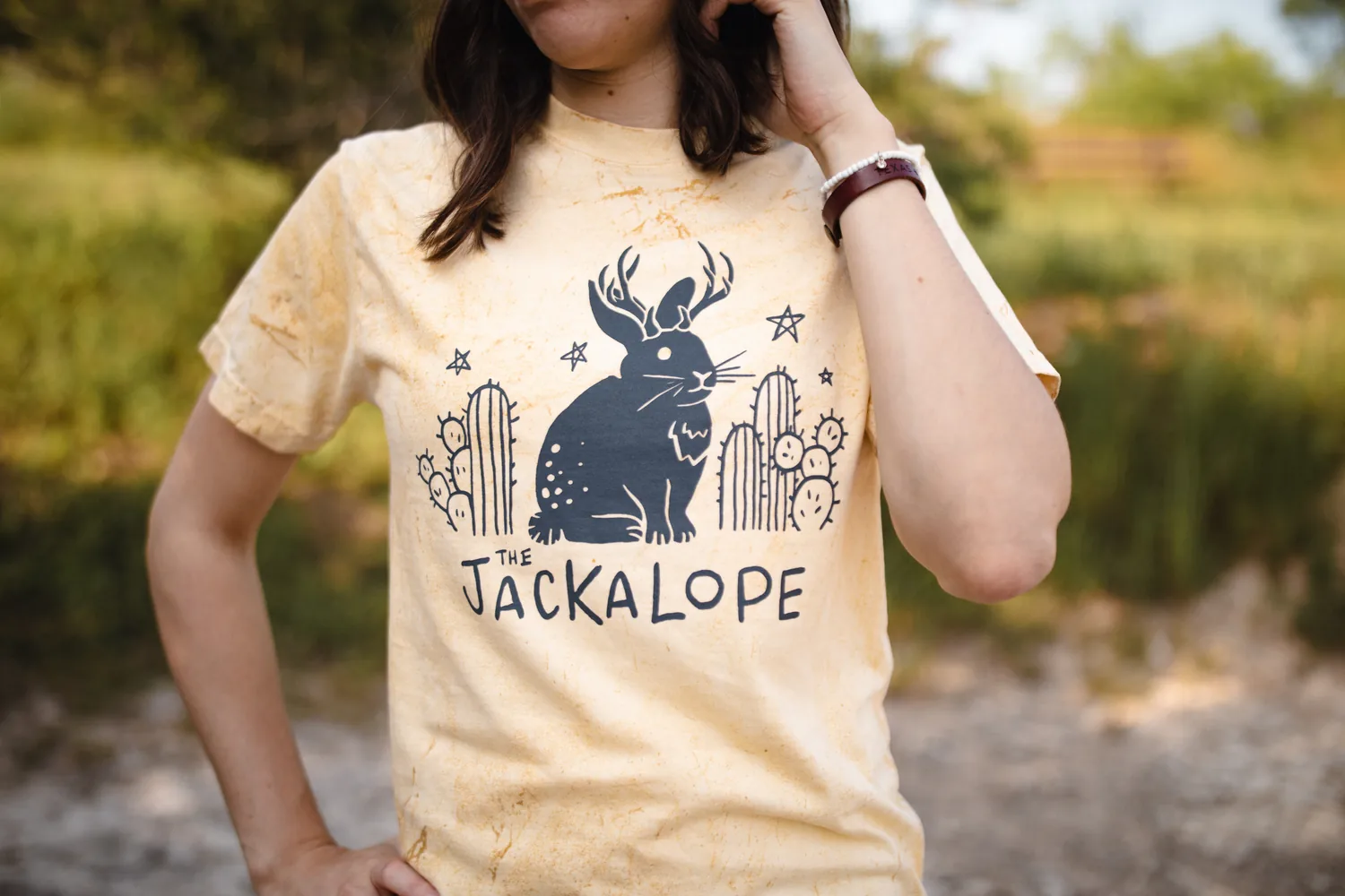 Yellow Jackalope graphic tee worn by Micah