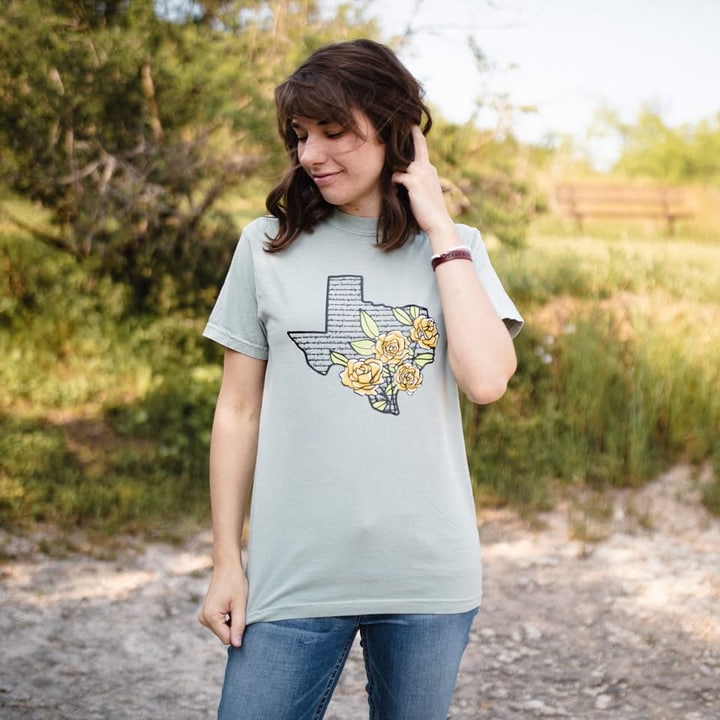 Micah Bechler wearing a Texas Wildflowers tee outdoors