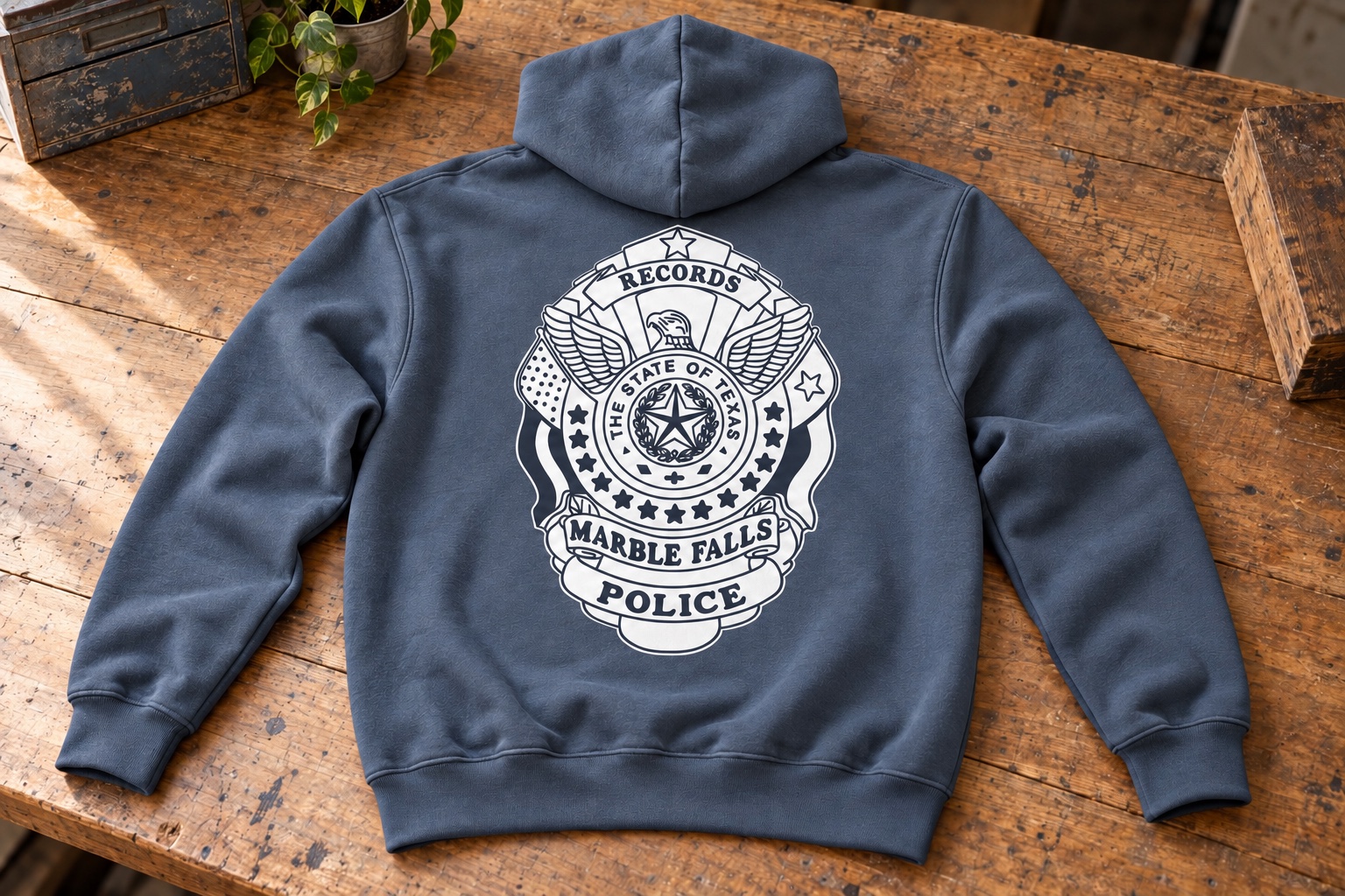Staged slate gray blue hoodie mockup with supplied Marble Falls Police Department Records badge artwork